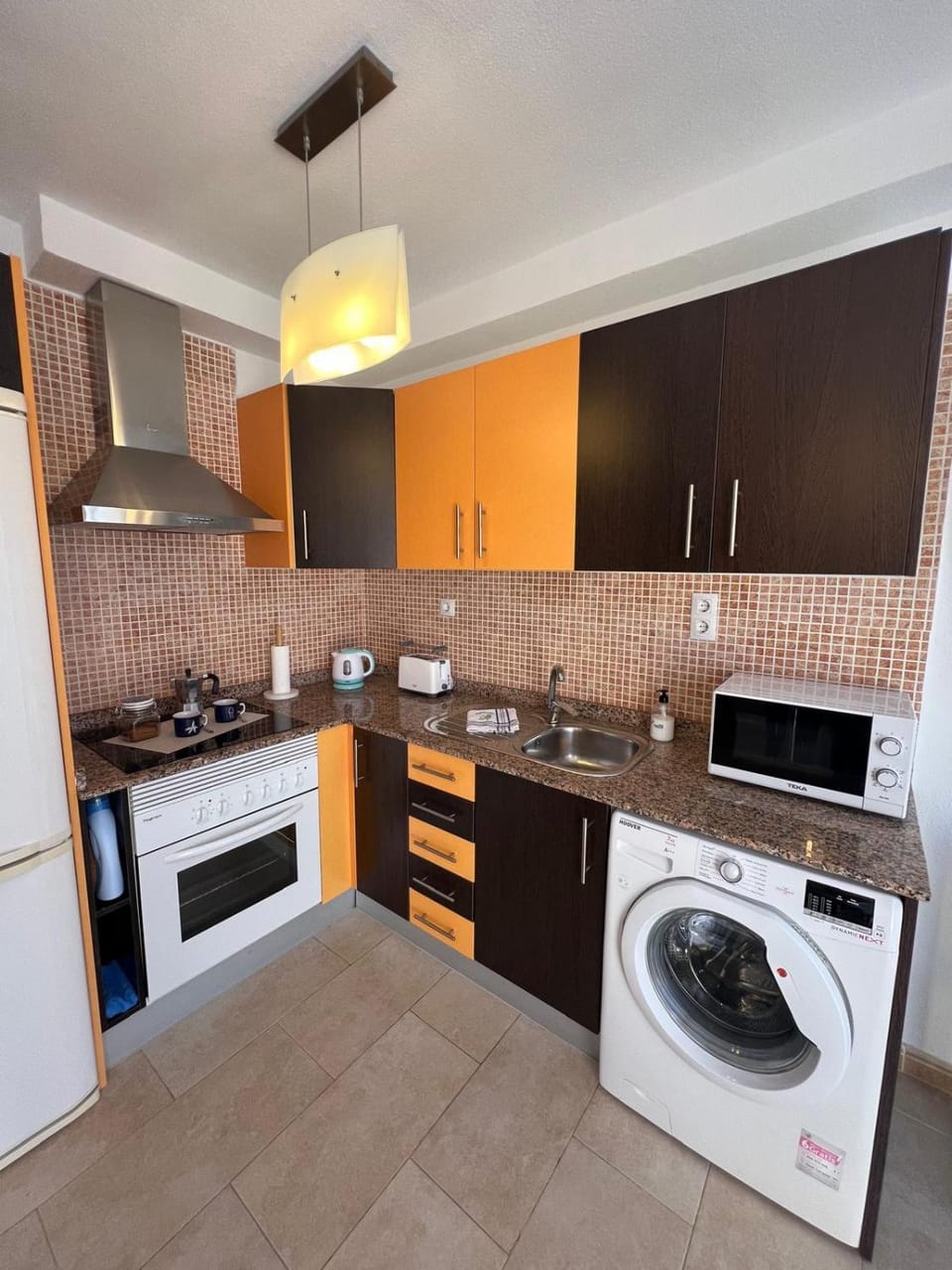 Kitchen or kitchenette, oven, stove, toaster, washing machine