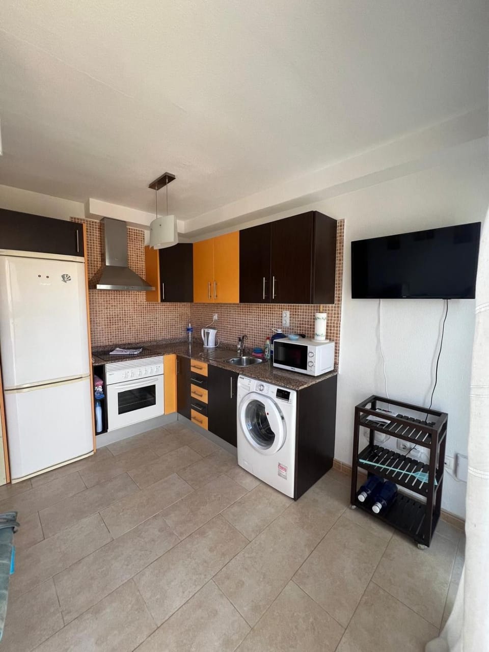 Kitchen or kitchenette, oven, stove, washing machine