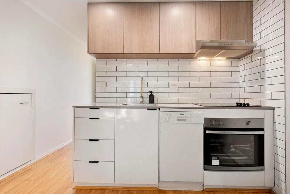 Kitchen or kitchenette, dishwasher, oven, stove