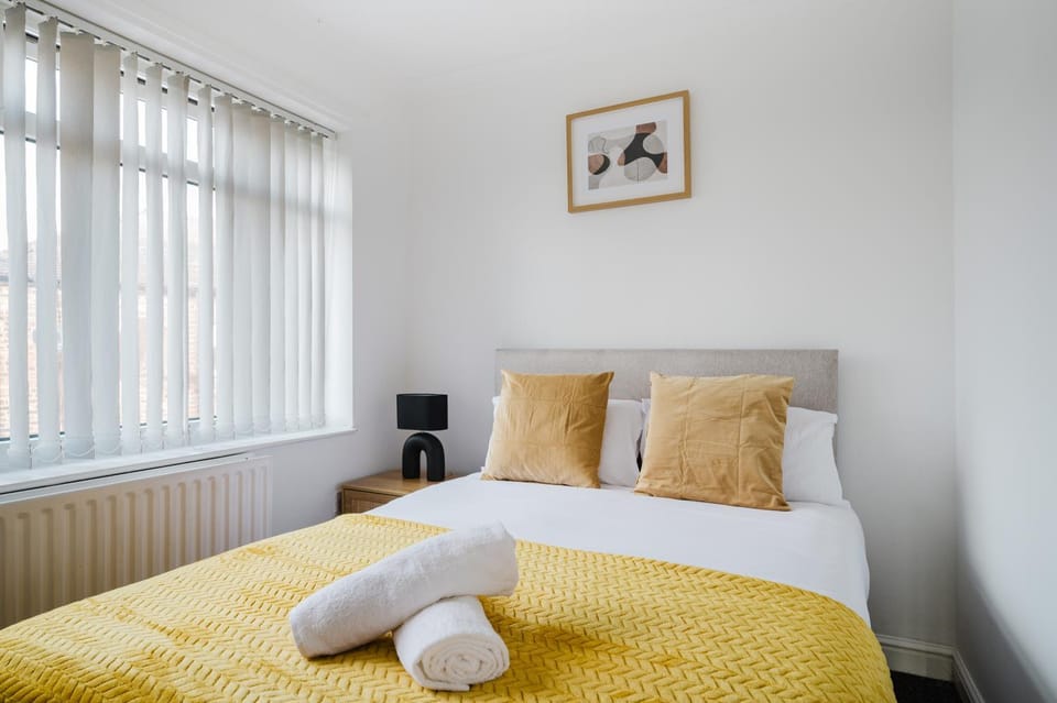 Bed, flat iron, hair dryier, towels, wardrobe