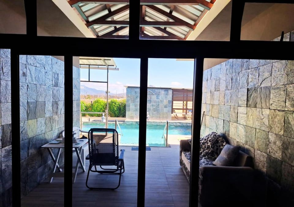 Patio, Day, Natural landscape, Living room, Seating area, Pool view, Swimming pool, sunbed