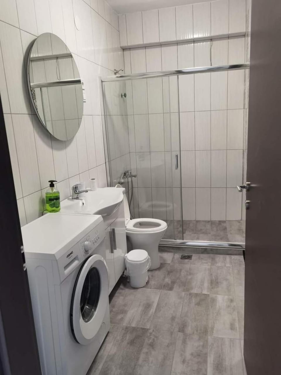 Shower, Toilet, bidet, hair dryier, towels, washing machine