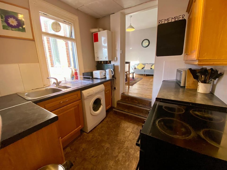 Kitchen or kitchenette, microwave, oven, stove, toaster, washing machine