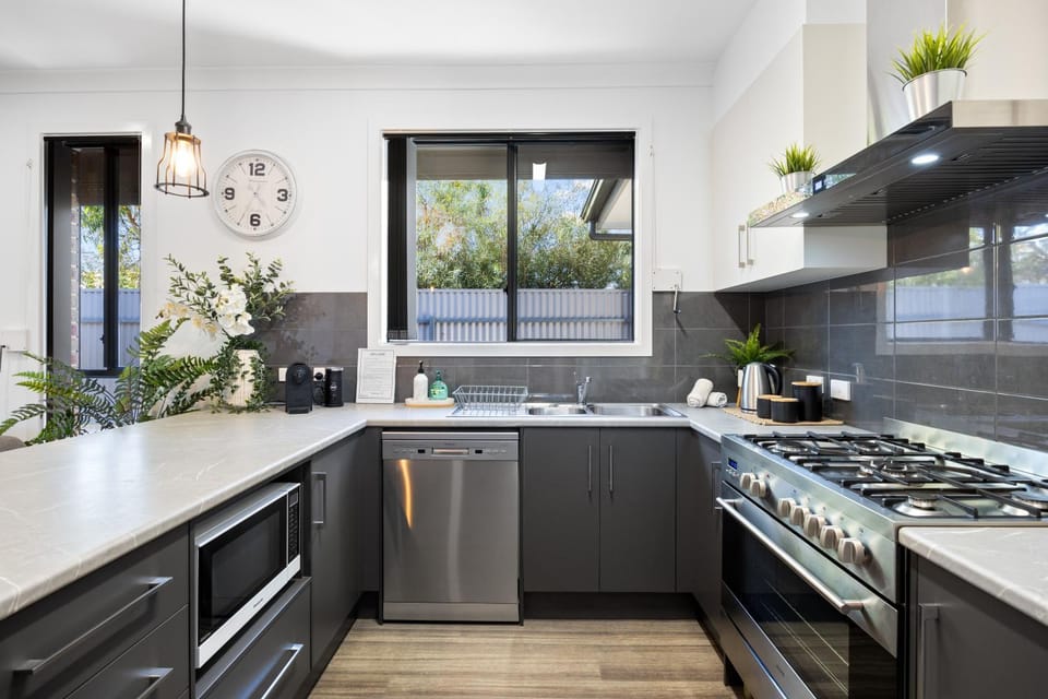Kitchen or kitchenette, dishwasher, oven, stove