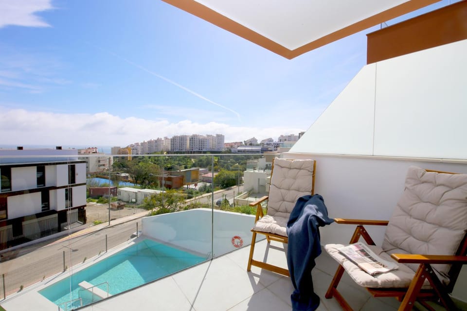 View (from property/room), Balcony/Terrace, Seating area, Pool view, Swimming pool