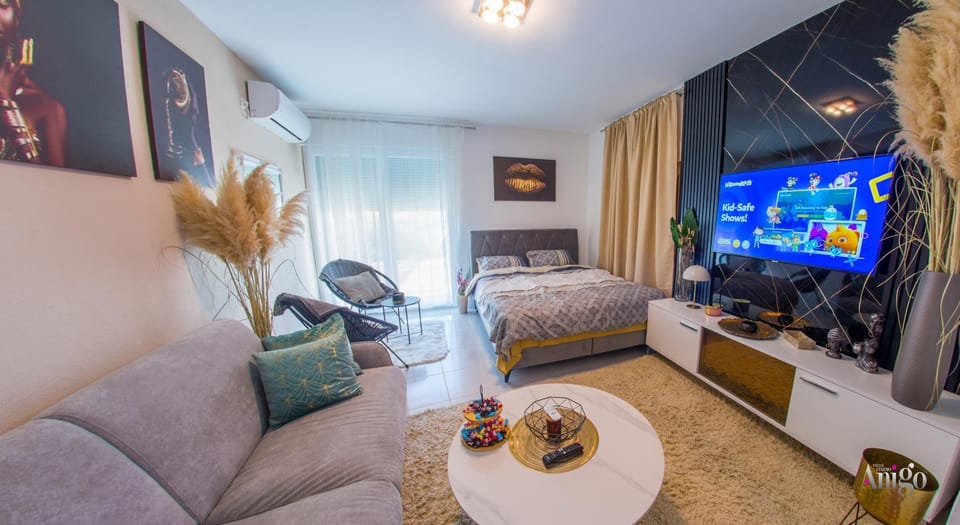 Bed, TV and multimedia, Living room, Seating area, air conditioner