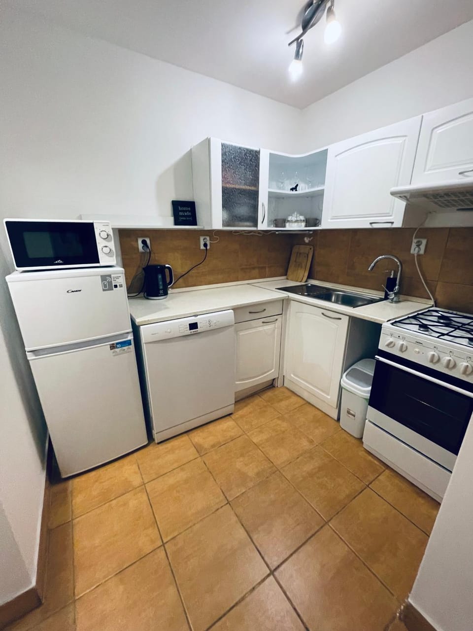Kitchen or kitchenette, dishwasher, oven, stove