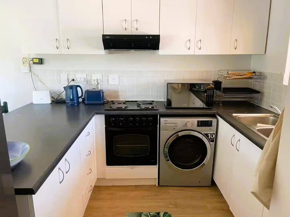 Kitchen or kitchenette, oven, stove, toaster, washing machine