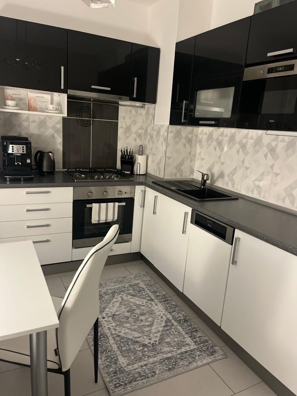 Kitchen or kitchenette, dishwasher, oven, stove