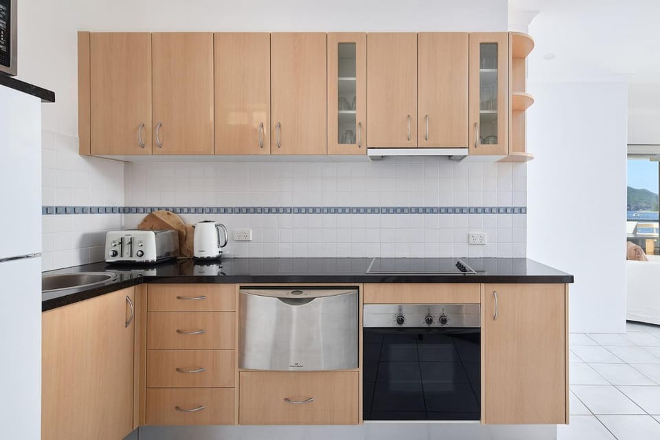 Kitchen or kitchenette, dishwasher, oven, stove, toaster