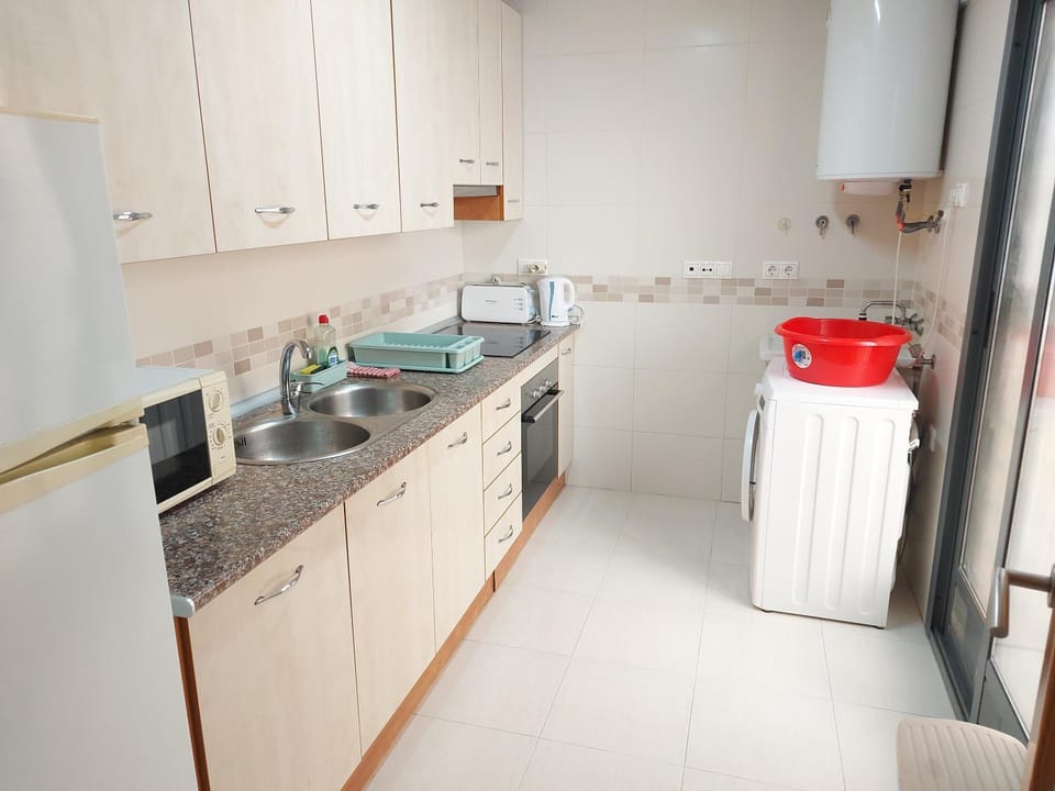 Kitchen or kitchenette, microwave, stove, washing machine