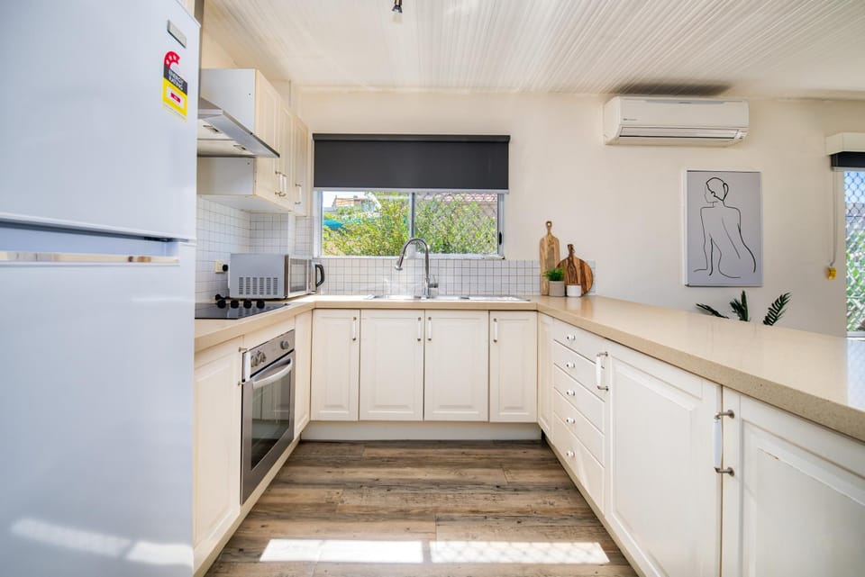 Kitchen or kitchenette, dishwasher, oven, stove