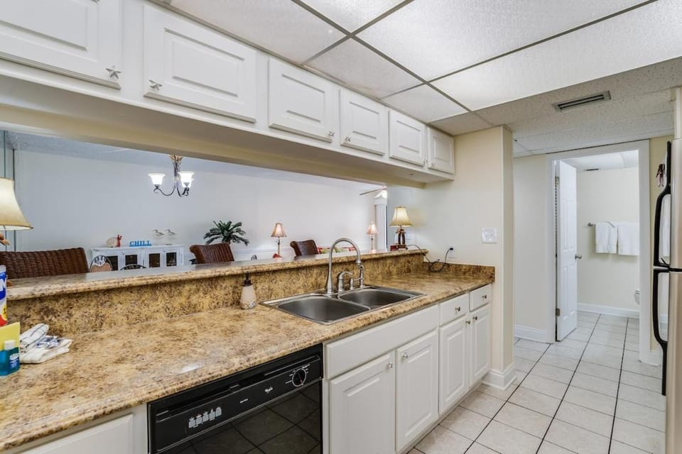 Kitchen or kitchenette, dishwasher, oven, stove