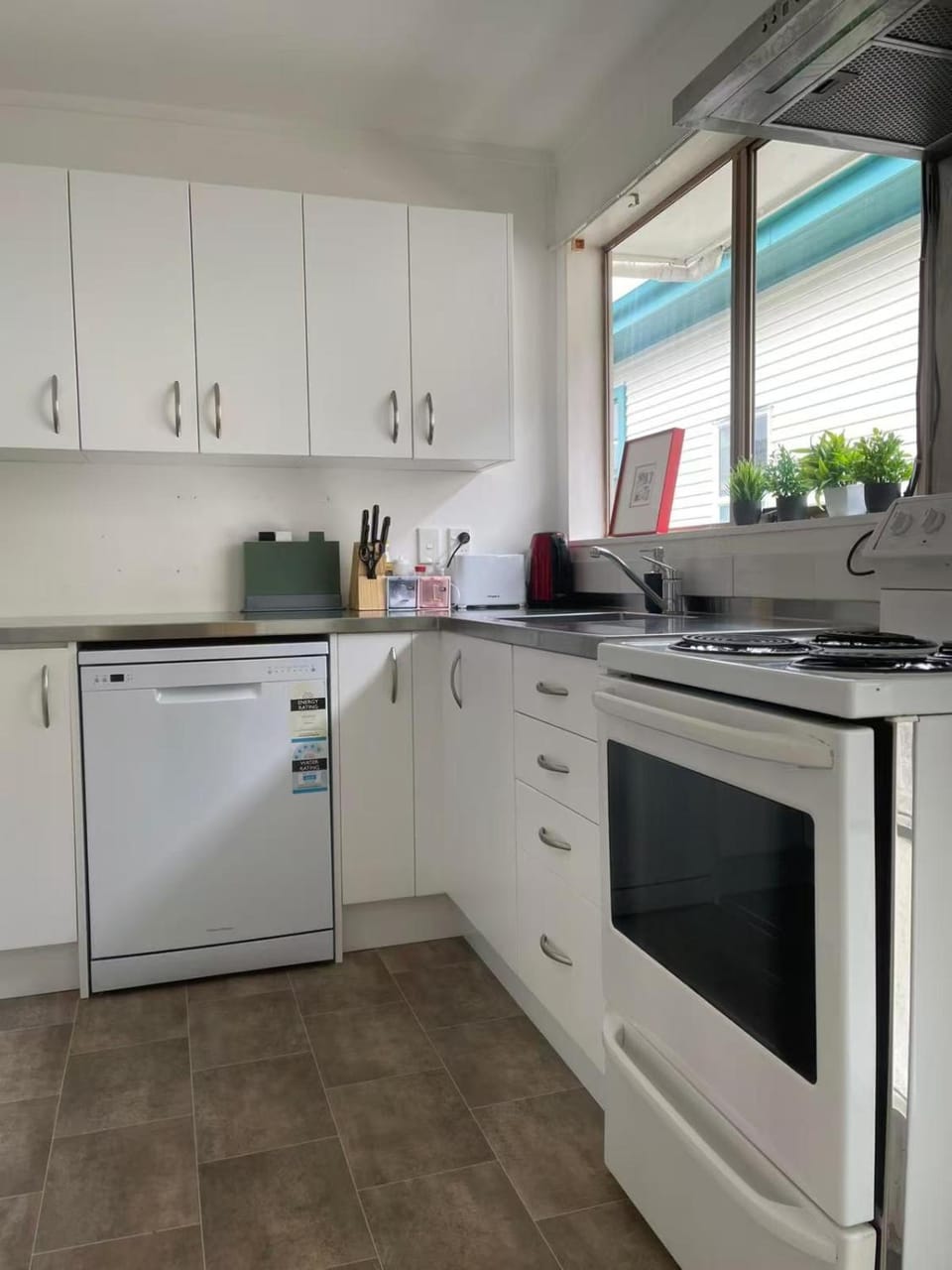 Kitchen or kitchenette, dishwasher, oven, stove