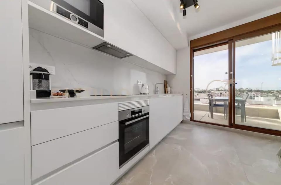 Kitchen or kitchenette, dishwasher, oven, stove