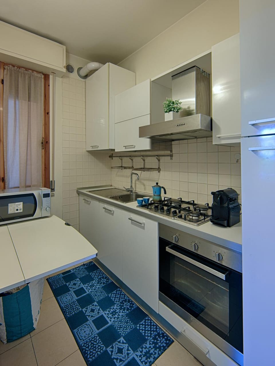 Kitchen or kitchenette, dishwasher, oven, stove, washing machine