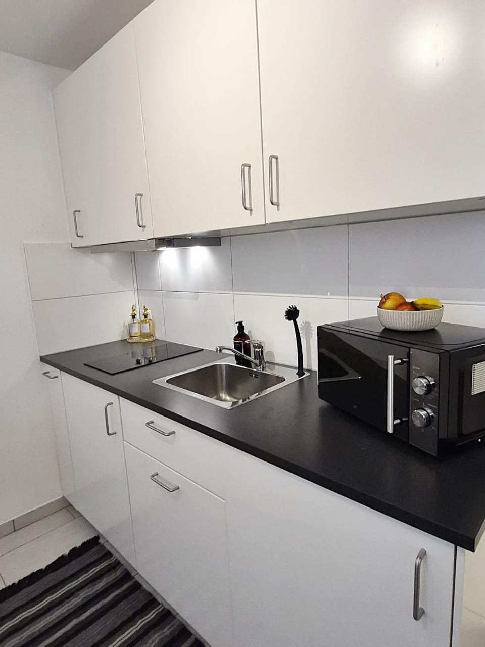 Kitchen or kitchenette, microwave, stove, toaster