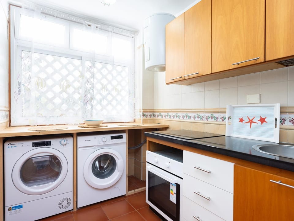 Kitchen or kitchenette, oven, stove, washing machine, dryer