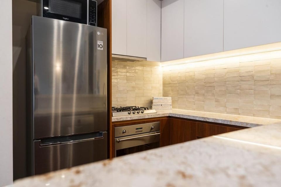 Kitchen or kitchenette, dishwasher, oven, stove