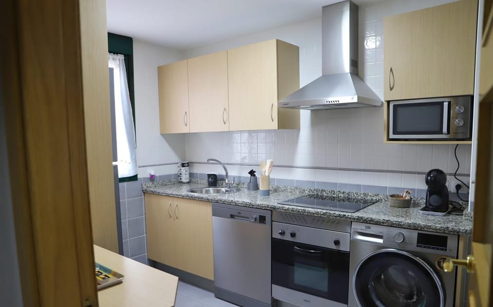 Kitchen or kitchenette, dishwasher, stove, toaster, washing machine