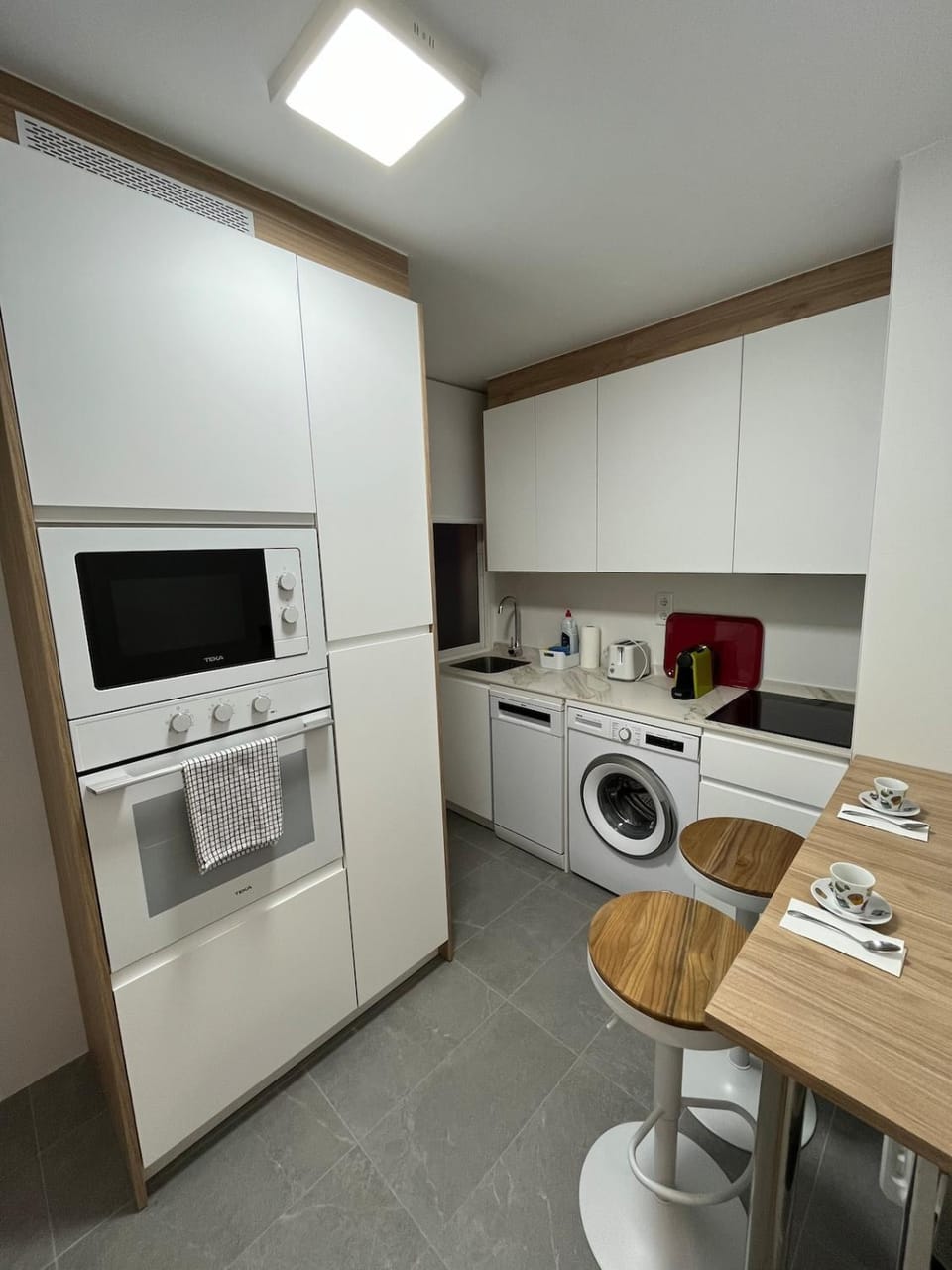 Kitchen or kitchenette, dishwasher, oven, stove, toaster, washing machine