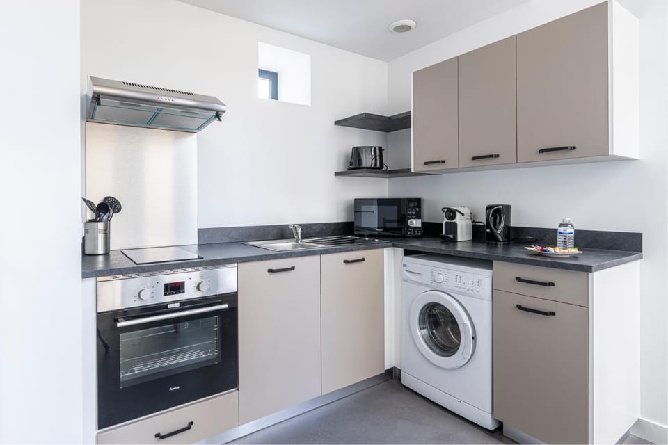 Kitchen or kitchenette, stove, toaster, washing machine