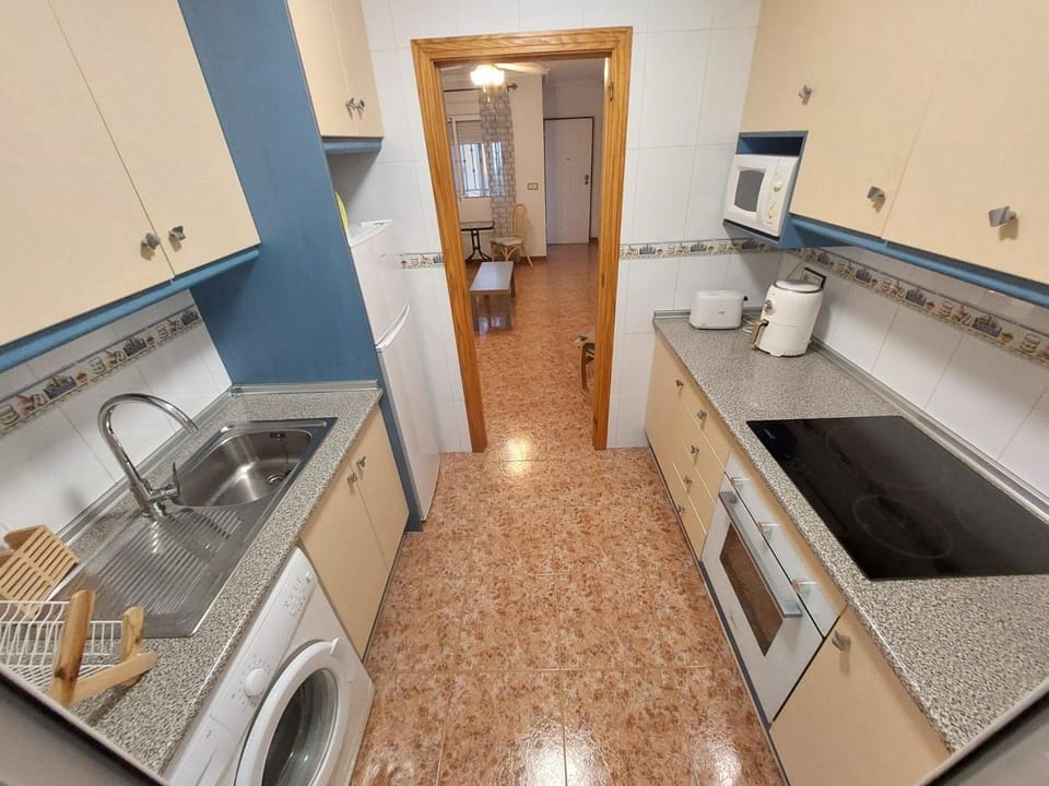 Kitchen or kitchenette, oven, stove, washing machine