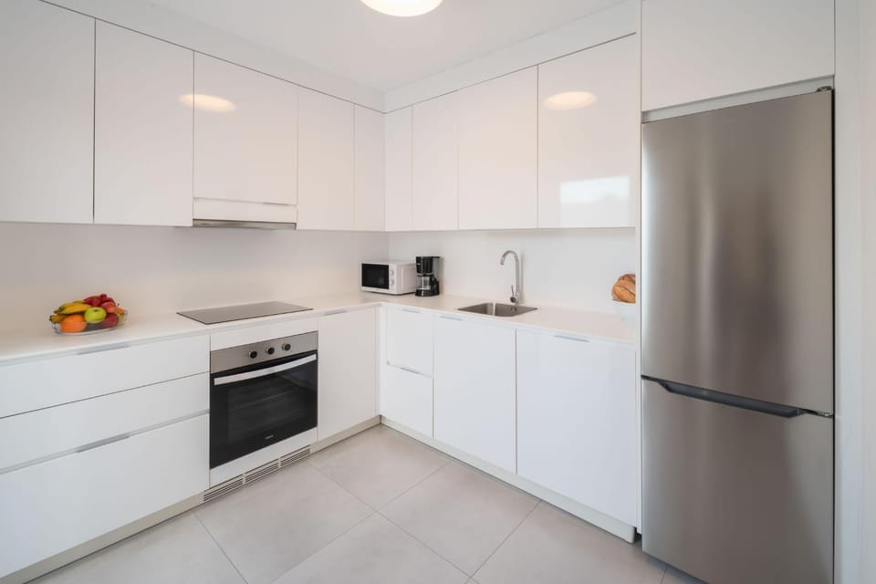 Kitchen or kitchenette, dishwasher, oven, stove