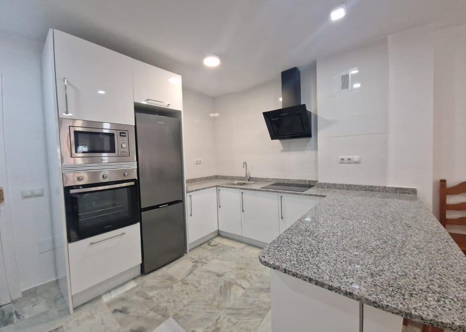 Kitchen or kitchenette, dishwasher, oven, stove
