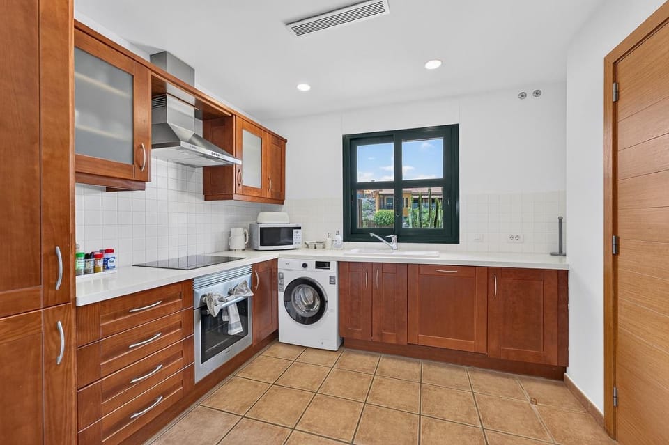 Kitchen or kitchenette, dishwasher, oven, stove, washing machine