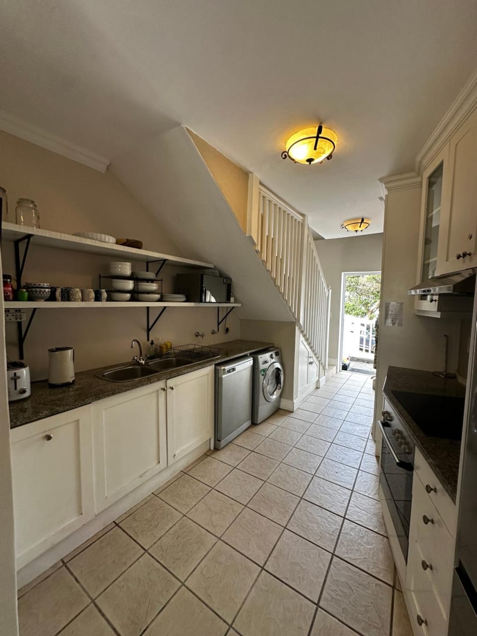 Kitchen or kitchenette, dishwasher, oven, stove