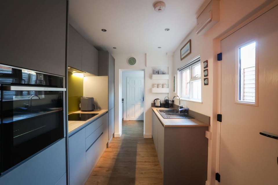 Kitchen or kitchenette, dishwasher, oven, stove