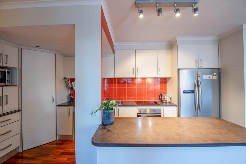 Kitchen or kitchenette, dishwasher, oven, stove