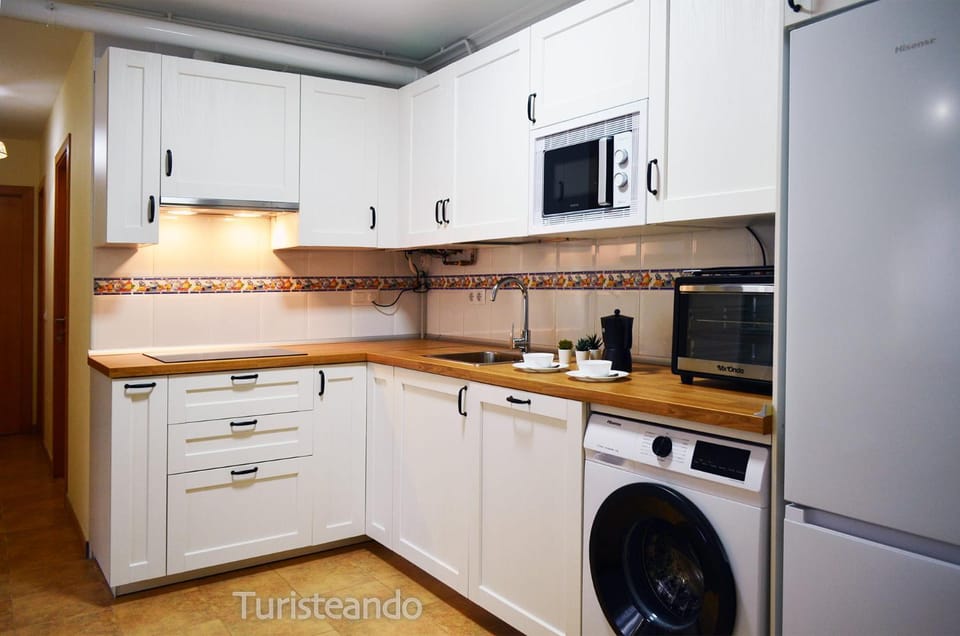 Kitchen or kitchenette, dishwasher, oven, stove, toaster, washing machine
