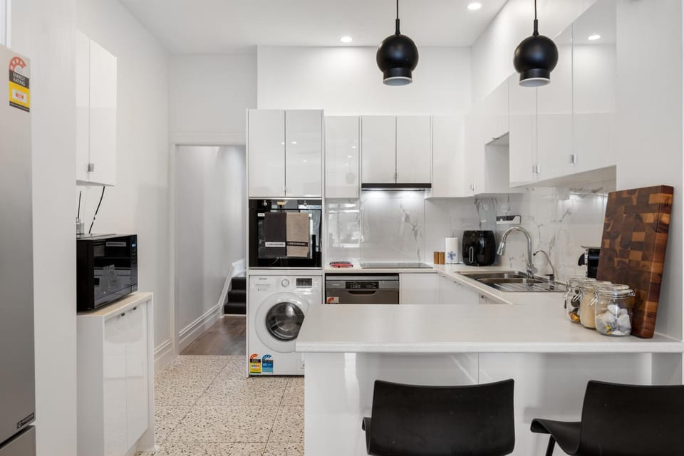 Kitchen or kitchenette, dishwasher, oven, stove, toaster, washing machine, dryer