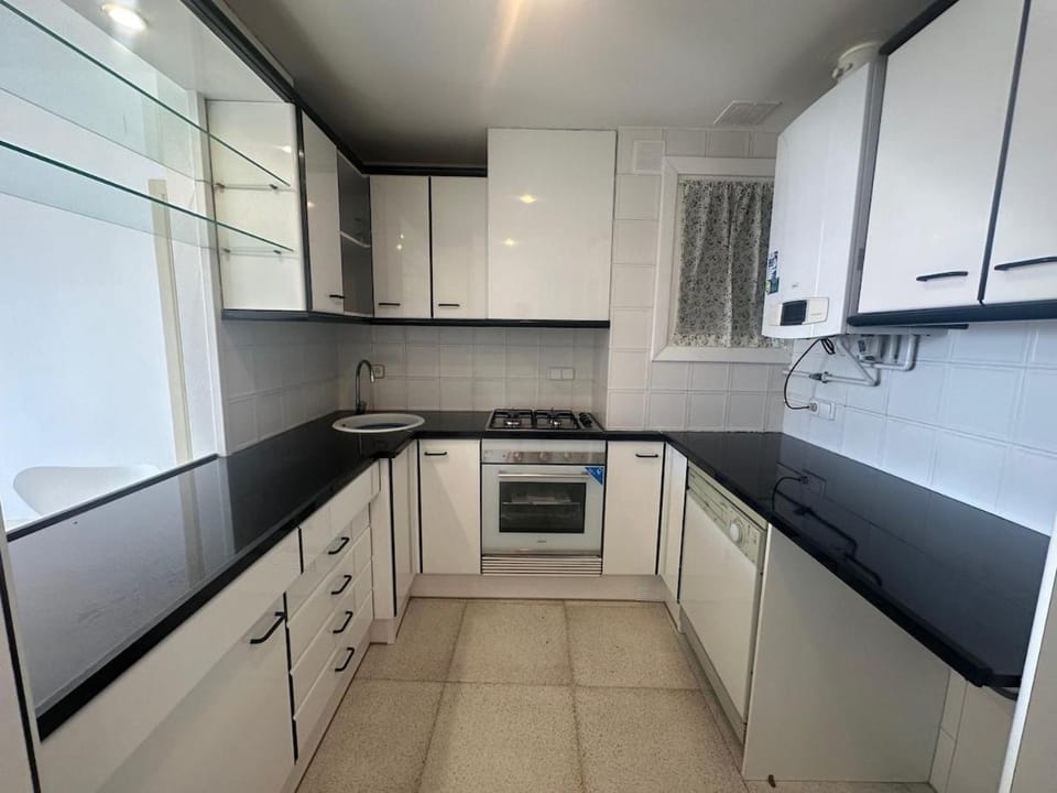 Kitchen or kitchenette, dishwasher, oven, stove
