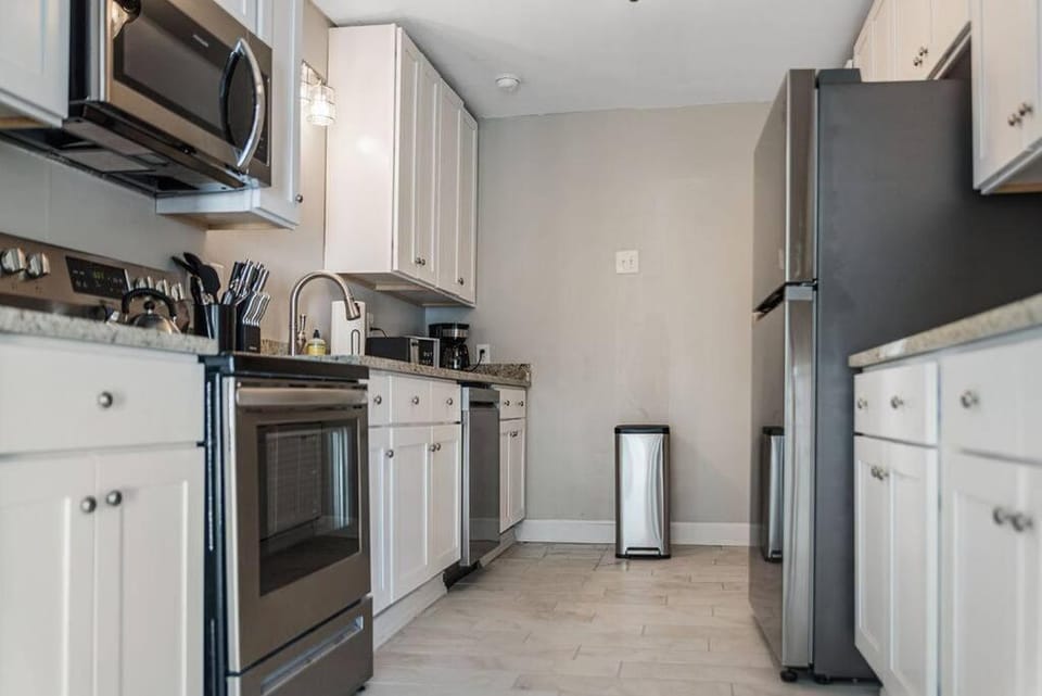 Kitchen or kitchenette, dishwasher, oven, stove