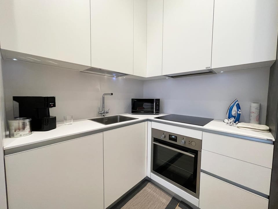 Kitchen or kitchenette, dishwasher, oven, stove