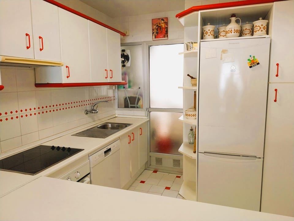 Kitchen or kitchenette, dishwasher, oven, stove