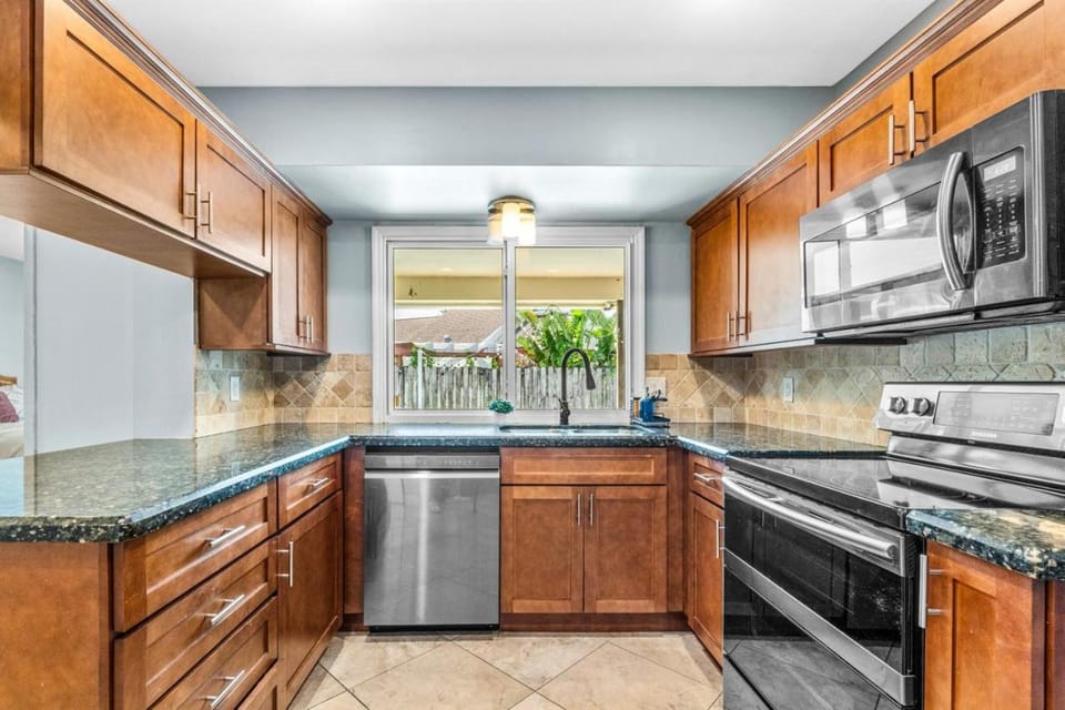 Pool view, dishwasher, microwave, oven, stove, toaster, kitchen