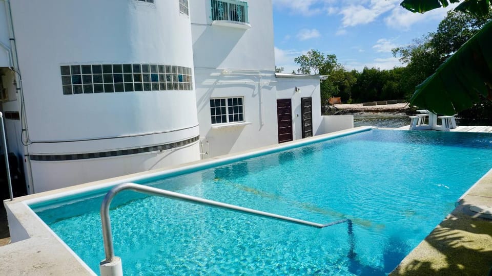 Property building, Day, Pool view, Swimming pool, sunbed