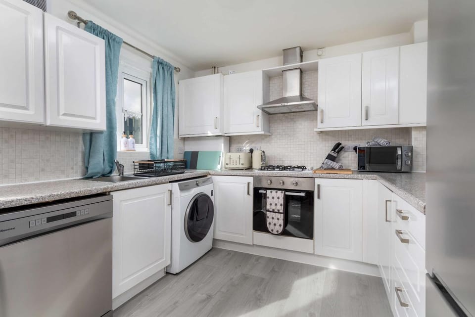 Kitchen or kitchenette, dishwasher, microwave, oven, stove, toaster, washing machine, dryer