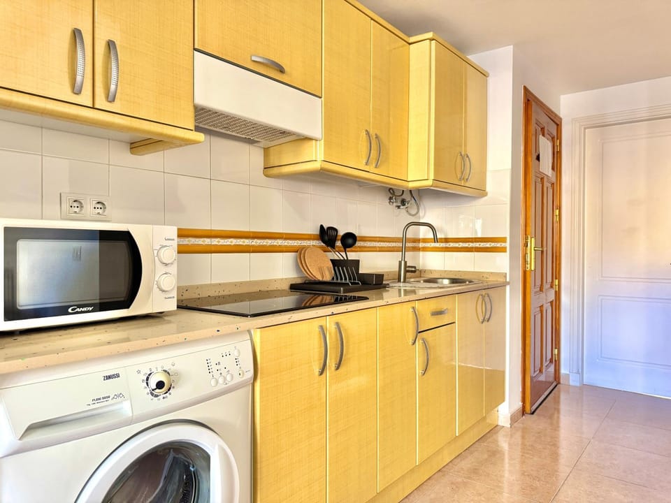 Kitchen or kitchenette, stove, washing machine