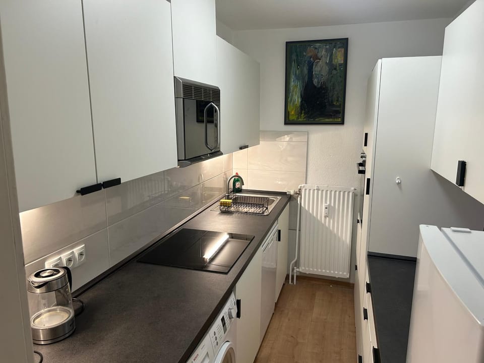 Kitchen or kitchenette, dishwasher, oven, stove