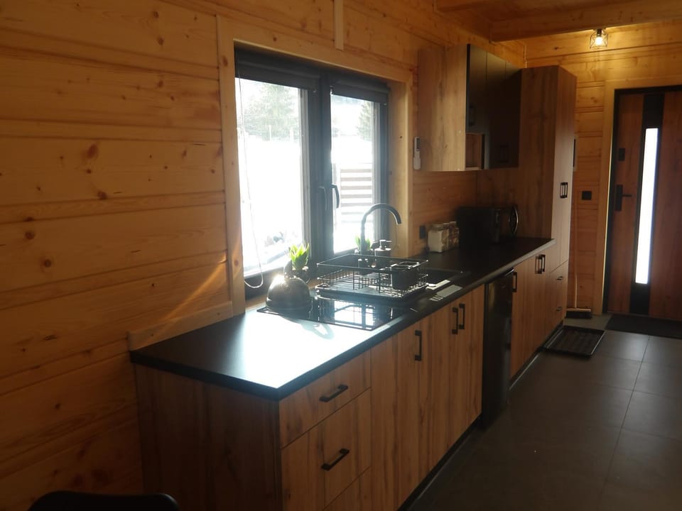 Kitchen or kitchenette, microwave, stove, washing machine