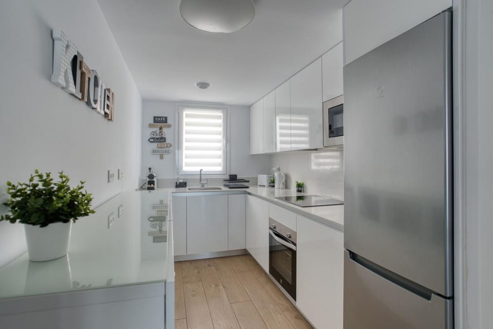 Kitchen or kitchenette, dishwasher, oven, stove