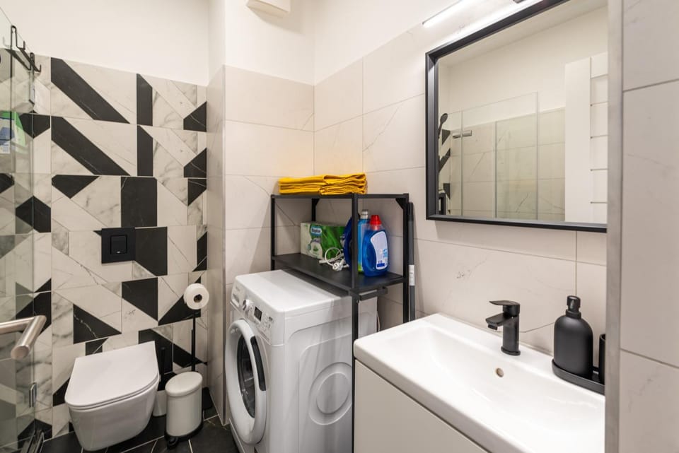 Bathroom, hair dryier, towels, washing machine