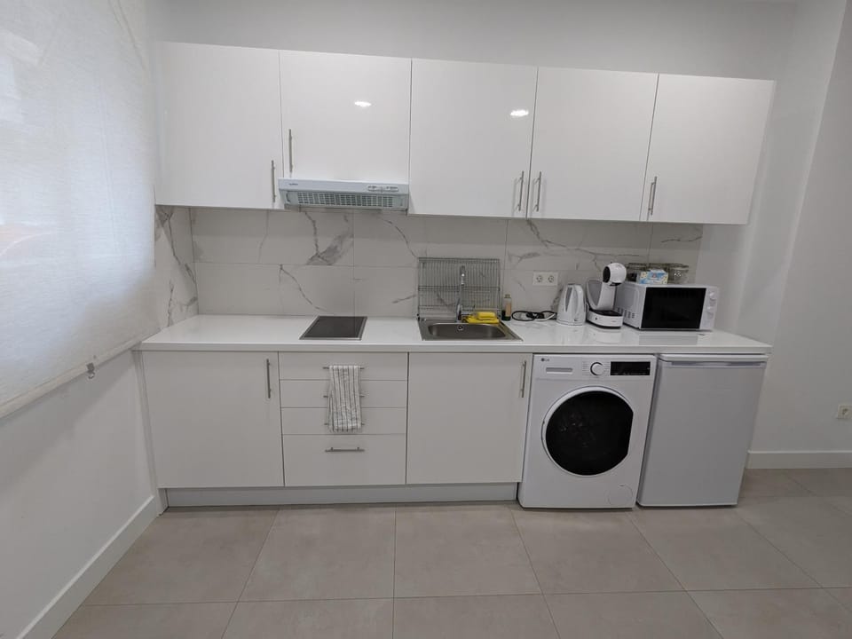 Kitchen or kitchenette, stove, washing machine