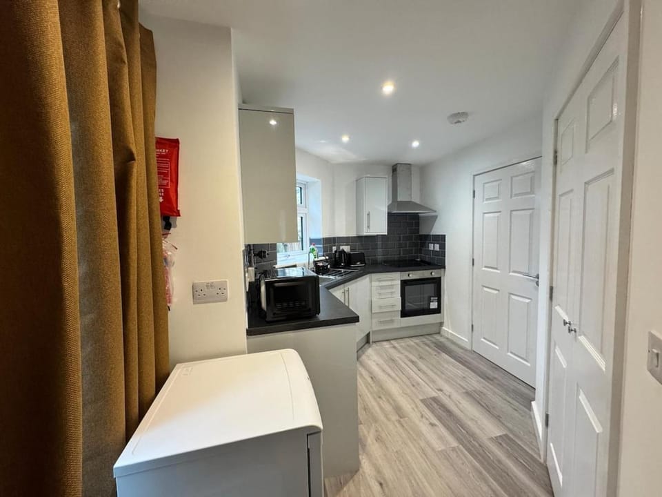 Kitchen or kitchenette, dishwasher, oven, stove