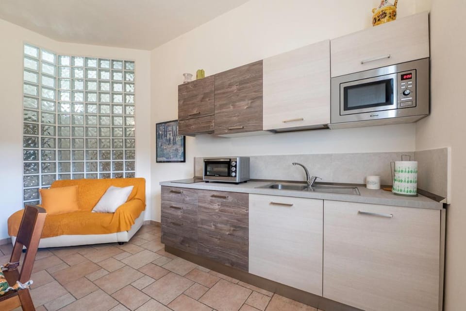Kitchen or kitchenette, microwave, stove, toaster, washing machine, kitchen